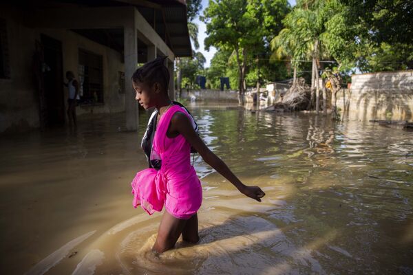 Bé gái đi trên con phố ngập lụt sau trận bão ở Haiti - Sputnik Việt Nam