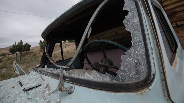 Xe tải bị vỡ cửa kính trên đường ở Martuni sau trận pháo kích. - Sputnik Việt Nam