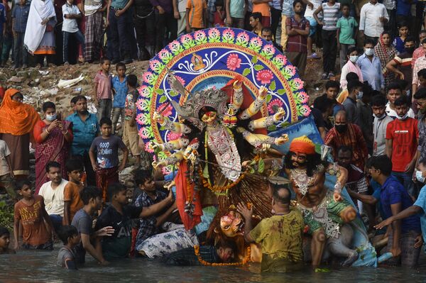 Người theo đạo Hindu gần tượng đất sét của nữ thần Durga trong ngày cuối cùng của lễ hội Durga Puja ở Dhaka, Bangladesh - Sputnik Việt Nam