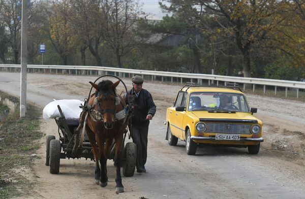 Một người dân với xe ngựa và ô tô trên đường ở làng Plop-Shtubei ở Moldova - Sputnik Việt Nam