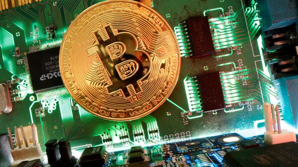 Đại diện của tiền ảo Bitcoin được nhìn thấy trên bo mạch chủ trong hình minh họa này được chụp vào ngày 24 tháng 4 năm 2020 - Sputnik Việt Nam