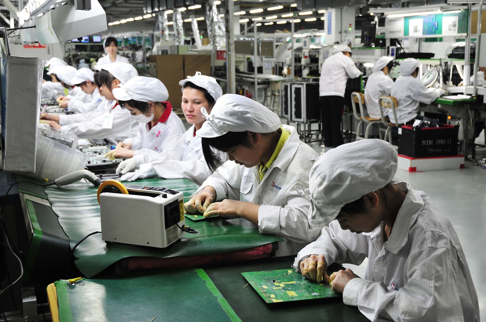 Công nhân làm việc trong phân xưởng của nhà máy Foxconn Technology Group ở Thâm Quyến, Trung Quốc - Sputnik Việt Nam, 1920, 05.10.2021