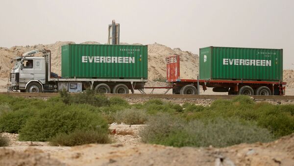 Một chiếc xe tải chở container Evergreen, chờ đi qua cổng chính của cảng El Ain El Sokhna đến Kênh đào Suez, Ai Cập ngày 24 tháng 3 năm 2021 - Sputnik Việt Nam