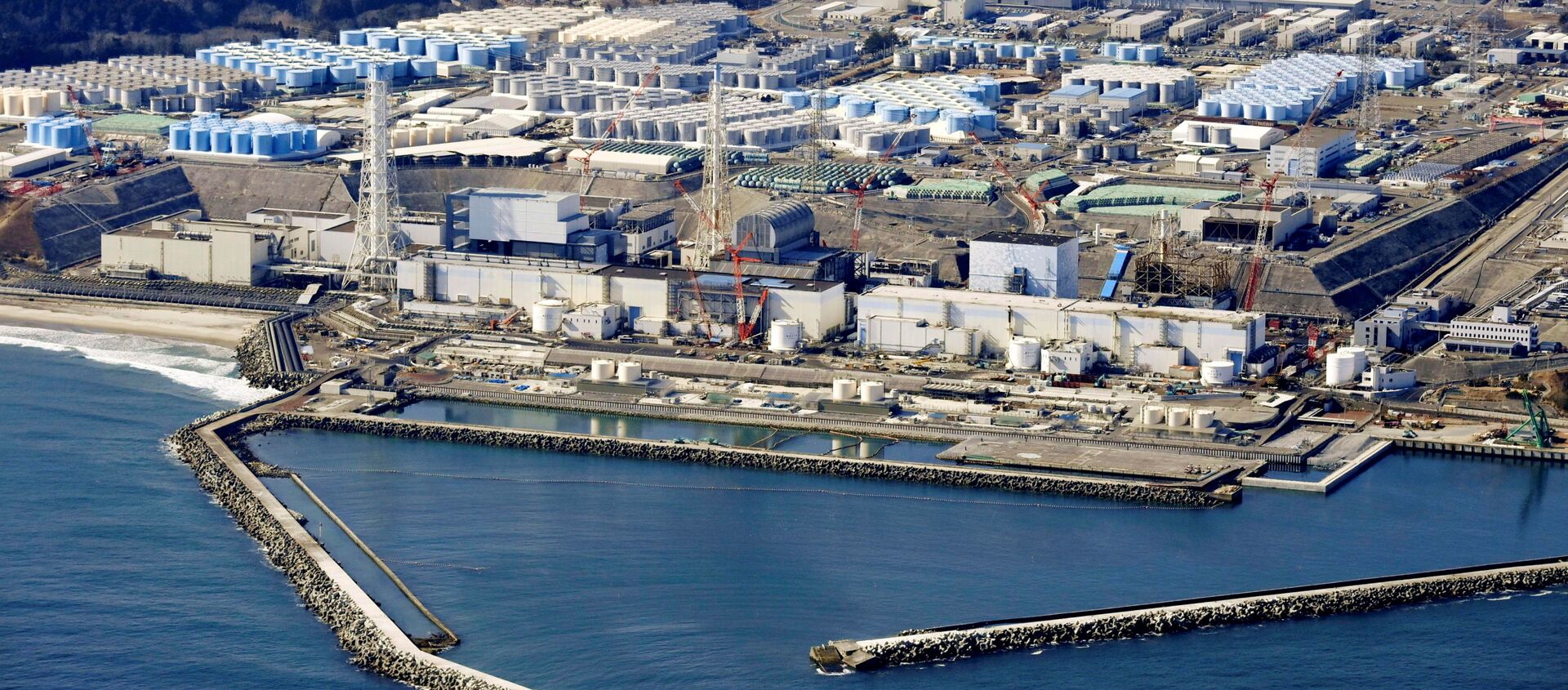 Ảnh chụp từ trên không cho thấy các bể chứa nước đã qua xử lý tại nhà máy điện hạt nhân Fukushima Daiichi bị sóng thần ở thị trấn Okuma, tỉnh Fukushima, Nhật Bản ngày 13 tháng 2 năm 2021, trong bức ảnh này do Kyodo chụp. - Sputnik Việt Nam, 1920, 14.04.2021