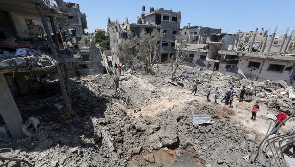 Người Palestine tập trung gần những ngôi nhà bị phá hủy sau cuộc không kích và pháo kích của Israel ở Dải Gaza - Sputnik Việt Nam
