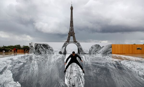 Người đàn ông tạo dáng trong tác phẩm khổng lồ của nghệ sĩ Pháp JR, dựng trên quảng trường Trocadero phía trước Tháp Eiffel ở Paris - Sputnik Việt Nam