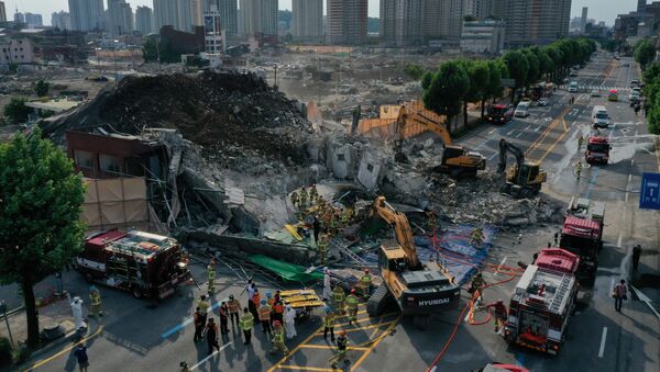  Lực lượng cứu hỏa tìm kiếm hành khách trên xe buýt mắc kẹt dưới đống đổ nát của một tòa nhà bị phá hủy ở Gwangju, Hàn Quốc. - Sputnik Việt Nam