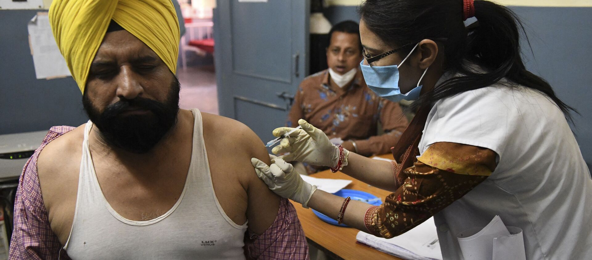 Một nhân viên y tế đã tiêm cho một người đàn ông một liều vắc xin coronavirus Covishield, ChAdOx1 nCoV-19, tại một bệnh viện dân sự ở làng Ajnala, cách Amritsar khoảng 28 km vào ngày 1 tháng 4 năm 2021 - Sputnik Việt Nam, 1920, 19.06.2021