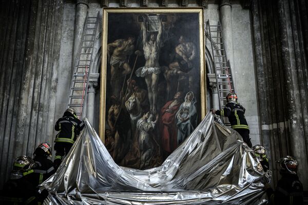Lính cứu hỏa Pháp phủ chăn chống cháy lên một bức tranh trong cuộc diễn tập bảo tồn các hiện vật nghệ thuật trưng bày tại Giáo đường Saint-André ở Bordeaux - Sputnik Việt Nam
