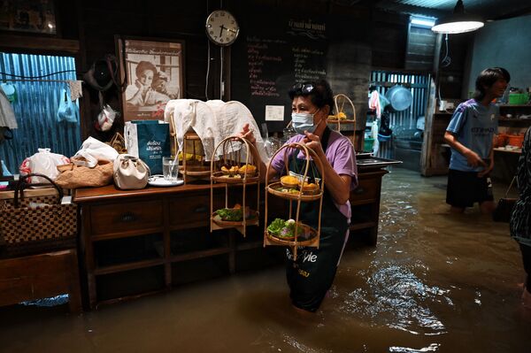 Nhân viên quán cà phê trong nước ngập Chaopraya Antique ở Thái Lan - Sputnik Việt Nam
