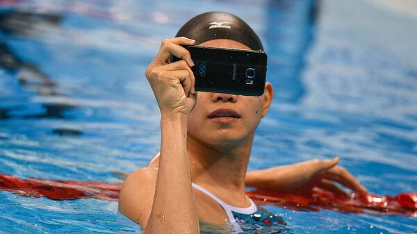 Pei Wong Lin (Đài Bắc Trung Hoa) khởi động trước khi bắt đầu trận chung kết bơi lội tại Thế vận hội mùa hè XXXI - Sputnik Việt Nam