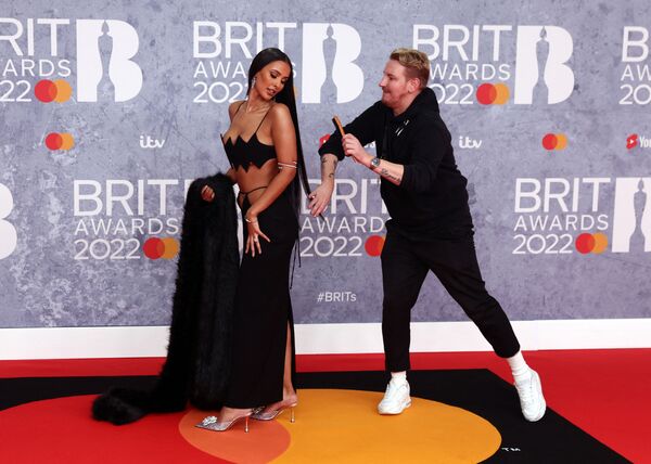 Trợ lý chỉnh sửa tóc cho người dẫn chương trình Anh Maya Jama tại Lễ trao giải Brit Awards ở London - Sputnik Việt Nam