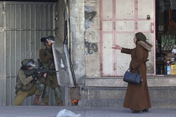 Người phụ nữ chỉ vào lực lượng an ninh Israel ở thành phố Hebron - Sputnik Việt Nam