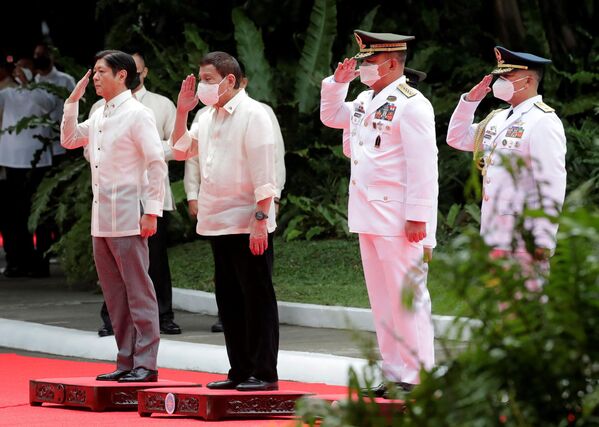 Tân tổng thống Philippines Ferdinand Marcos Jr. và Tổng thống sắp mãn nhiệm Rodrigo Duterte được chào đón trong lễ nhậm chức của ông Marcos trong khuôn viên Phủ Tổng thống Malacañang ở Manila. - Sputnik Việt Nam