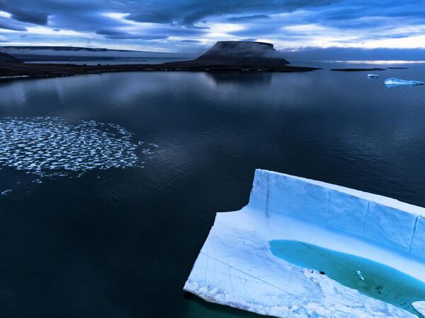 Mẩu băng đang tan bên trong tảng băng ngoài khơi bờ biển Pituffik, Greenland. - Sputnik Việt Nam