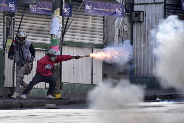 Người biểu tình ném pháo vào cảnh sát trong cuộc tuần hành phản đối ở La Paz. - Sputnik Việt Nam