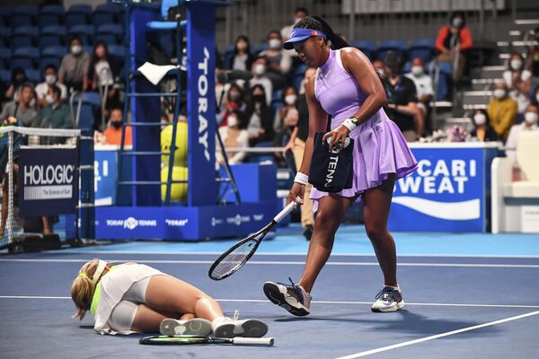 Tay vợt Nhật Bản Naomi Osaka chạy đến giúp đỡ Daria Saville của Australia sau khi cô bị thương trong trận đấu đơn nữ của hai VĐV trong ngày thứ hai của Giải quần vợt mở rộng Pan Pacific ở Tokyo. - Sputnik Việt Nam