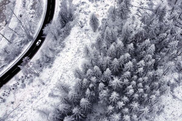 Chiếc ô tô chạy qua vùng tuyết phủ ở vùng núi Harz gần Schierke, Đức. - Sputnik Việt Nam