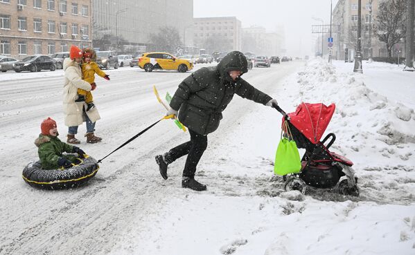 Người đi bộ trên phố Leninsky Prospekt (Nga) ngập tuyết ở Moskva. - Sputnik Việt Nam