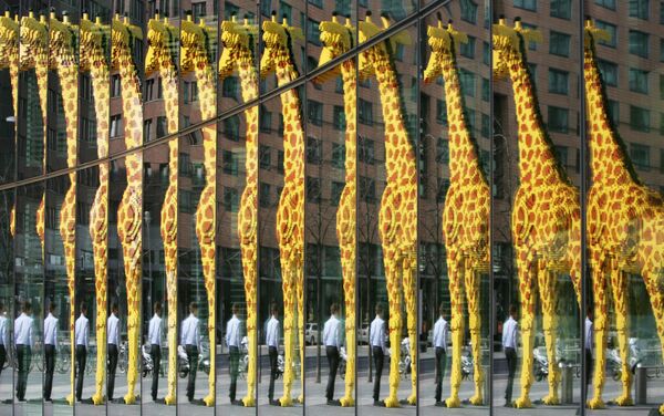Con hươu cao cổ khổng lồ làm từ các mảnh ghép Lego phản chiếu trên mặt tiền bằng kính ở Berlin. - Sputnik Việt Nam