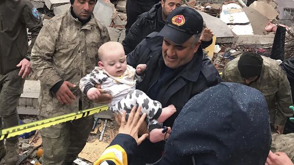 Một đứa trẻ được giải cứu khỏi tòa nhà bị sập ở Malatya Thổ Nhĩ Kỳ hôm thứ Hai ngày 6/2/2023 - Sputnik Việt Nam