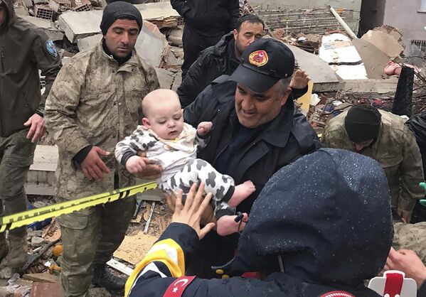 Đứa trẻ được giải cứu khỏi tòa nhà bị phá hủy ở Malatya, Thổ Nhĩ Kỳ. - Sputnik Việt Nam