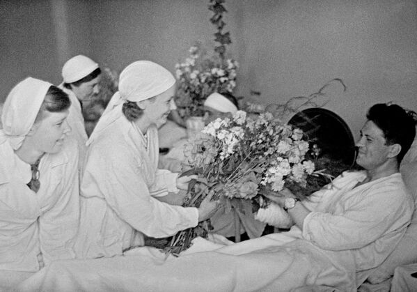 Chiến tranh Vệ quốc Vĩ đại 1941-1945. Hoa tặng những người lính bị thương trong bệnh viện ở Moskva. 1941. - Sputnik Việt Nam