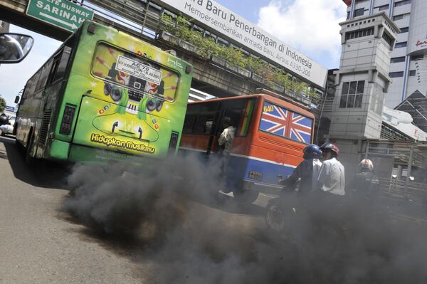 Chiếc xe buýt chạy bằng động cơ diesel thải ra vệt chất ô nhiễm ở Jakarta. - Sputnik Việt Nam