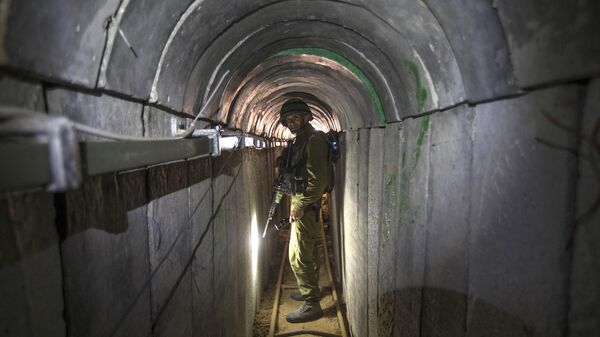 Trong bức ảnh chụp thứ Sáu, ngày 25 tháng 7 năm 2014, một sĩ quan quân đội Israel đưa các nhà báo đi thăm một đường hầm được cho là được phiến quân Palestine sử dụng để thực hiện các cuộc tấn công xuyên biên giới vào biên giới Dải Israel-Gaza. - Sputnik Việt Nam