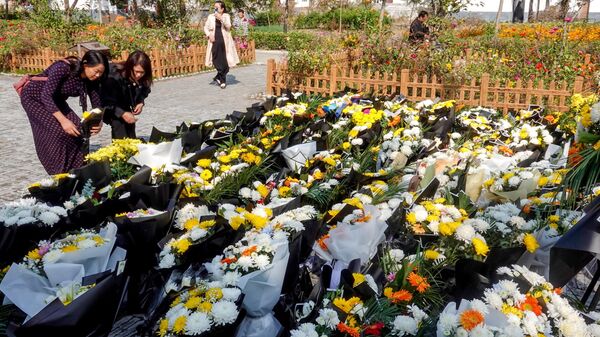 Người dân đặt hoa tại nơi ông Lý Khắc Cường từng làm việc - Sputnik Việt Nam