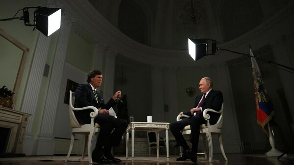 Russian President Vladimir Putin listens to a question during an interview with US journalist Tucker Carlson at the Kremlin in Moscow, Russia. - Sputnik Việt Nam