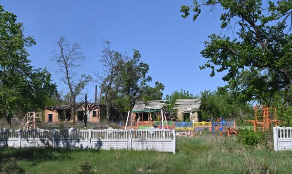 Sân chơi trẻ em bị hư hại do pháo kích ở làng Tavolzhanka, tỉnh Kharkov - Sputnik Việt Nam