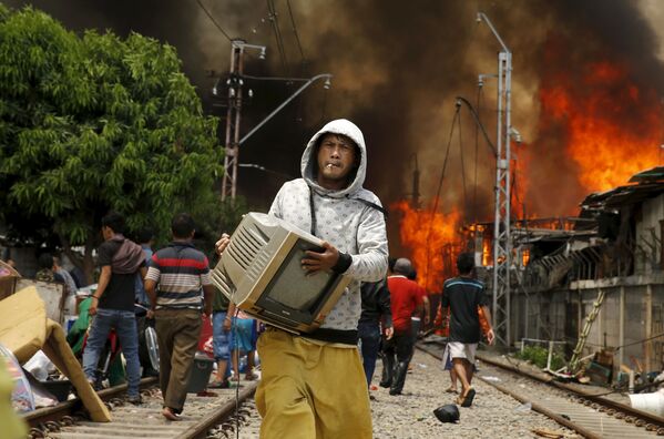Một người đàn ông liều mình cứu chiếc TV khỏi lưỡi lửa ở Indonesia - Sputnik Việt Nam