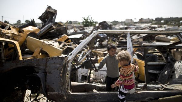Các trẻ em Palestine chơi trong nghĩa địa xe ở khu phố nghèo thuộc Dải Gaza - Sputnik Việt Nam