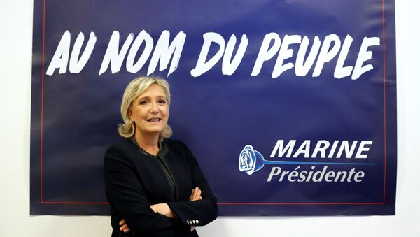 France's far-right National Front (FN) leader Marine Le Pen poses in front of a poster for her 2017 French presidential election campaign as she inaugurates her party campaign headquarters L'Escale in Paris, France, November 16, 2016. - Sputnik Việt Nam