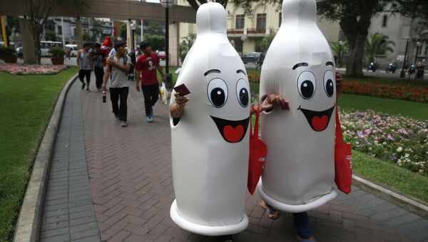 Two women dressed as condoms walk during an awareness program on International Condom Day in Lima, Peru. - Sputnik Việt Nam