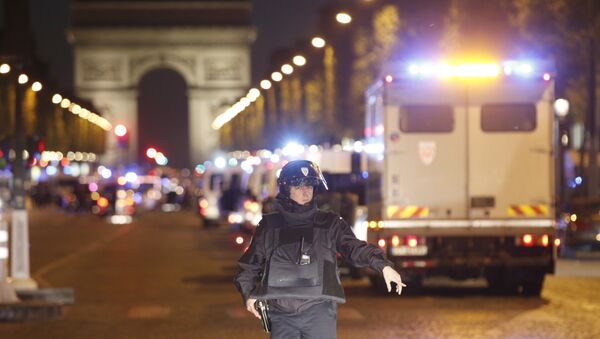 A police officer stands guard after a fatal shooting in which a police officer was killed along with an attacker on the Champs Elysees in Paris, France, Thursday, April 20, 2017. - Sputnik Việt Nam