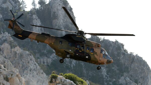 A Turkish army Cougar helicopter flies over the Saint-Hilarion mountain shane near Kyrenia during a search and rescue exercise in northern Cyprus, Tuesday, June 16, 2009 amid a dispute with Greek Cypriots over oil and gas exploration off the island. - Sputnik Việt Nam