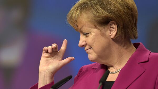 German Chancellor and chairwoman of the German Christian Democrats, CDU, Angela Merkel, points with her fingers during a visit to the convention venue prior to the 27. party convention in Cologne, Germany, Monday, Dec. 8, 2014. - Sputnik Việt Nam