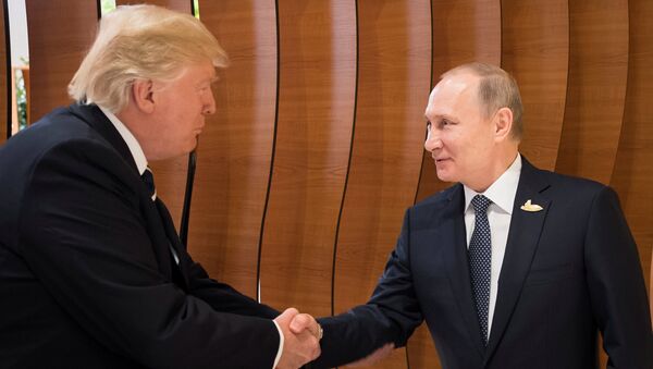 U.S. President Donald Trump and Russia's President Vladimir Putin shake hands during the G20 Summit in Hamburg, Germany in this still image taken from video, July 7, 2017 - Sputnik Việt Nam