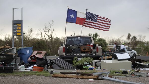 The Texas state flag and American flag wave in the wind over an area of debris left behind in the wake of Hurricane Harvey, Sunday, Aug. 27, 2017, in Rockport, Texas. - Sputnik Việt Nam