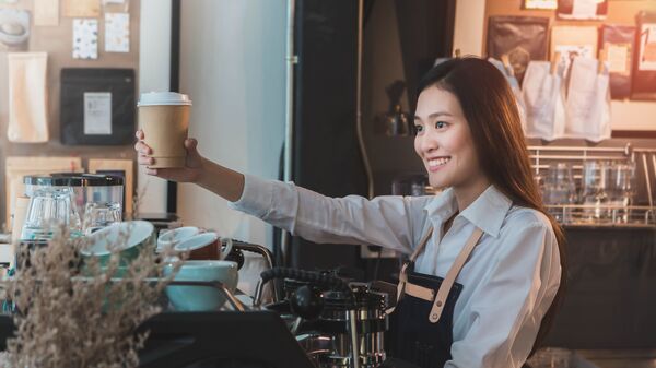Азиатская девушка-бариста с чашкой кофе - Sputnik Việt Nam