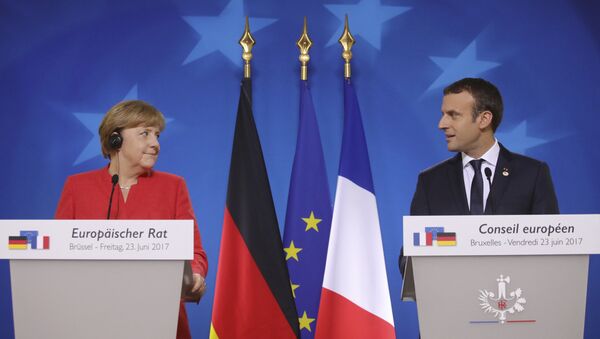 German Chancellor Angela Merkel, left, and French President Emmanuel Macron prepare to address the media at an EU summit in Brussels on Friday, June 23, 2017. - Sputnik Việt Nam