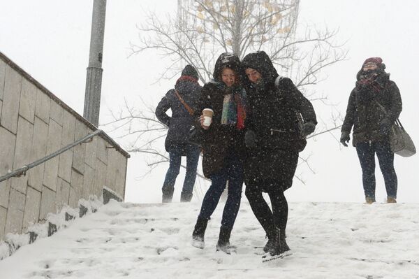 Những cô gái trên bậc thang xuống lối ngầm dưới lòng đất khi tuyết rơi ở Moskva - Sputnik Việt Nam
