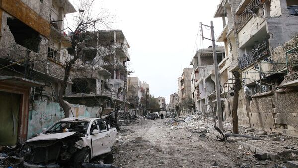 Damaged cars and buildings are seen in the besieged town of Douma, Eastern Ghouta, Damascus, Syria - Sputnik Việt Nam