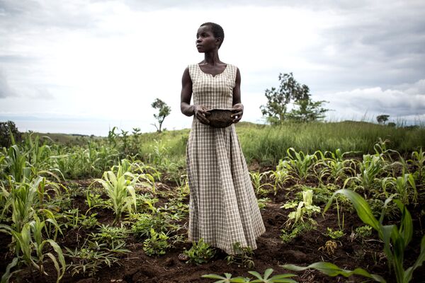 Người phụ nữ gieo hạt trong vùng lân cận trại tị nạn tạm thời cho những người di tản bắt buộc và người hồi hương, Cộng hòa Dân chủ Congo - Sputnik Việt Nam