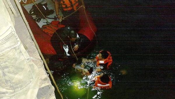 Các lực lượng chức năng lặn xuống nước để đưa thi thể nạn nhân lên bờ. - Sputnik Việt Nam