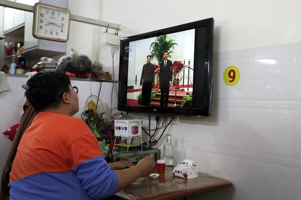Người đàn ông đang xem tin tức truyền hình về chuyến thăm chính thức Trung Quốc của Kim Jong Un - Sputnik Việt Nam