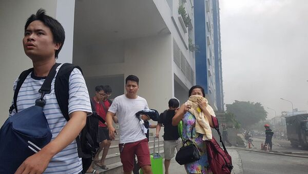 Người dân lại một lần nữa tháo chạy khỏi chung cư Carina Plaza khi ngọn lửa tái bùng phát vào trưa 23.3 - Sputnik Việt Nam