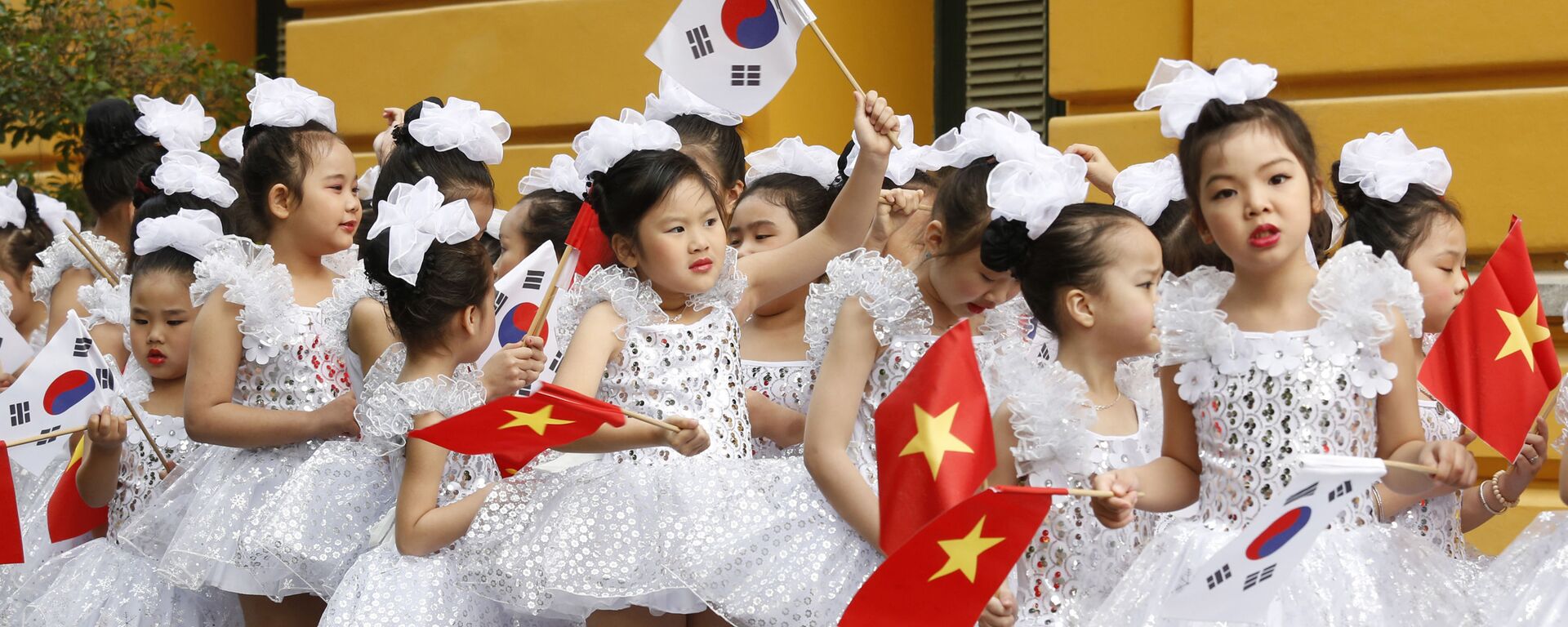 Trẻ em Việt Nam với những lá cờ của Việt Nam và Hàn Quốc đang chờ đợi Tổng thống Hàn Quốc Moon Jae-in tại Hà Nội, Việt Nam - Sputnik Việt Nam, 1920, 14.05.2019